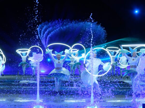 Professional dancer among the light and water for kiss of the sea show