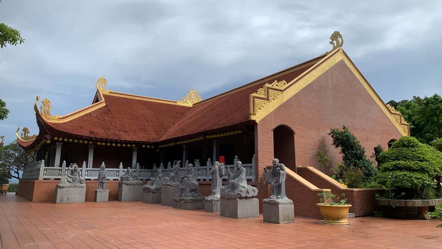 The statue of the monks next to the small hall
