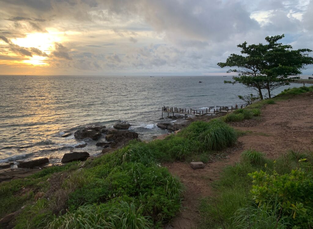 Green grass, small pier and sunset